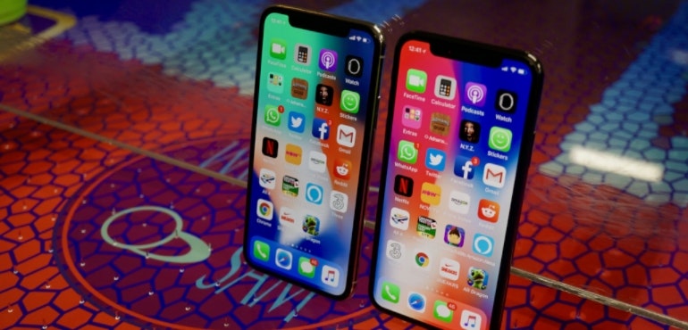 iPhone X two handsets stood up app tray hero size